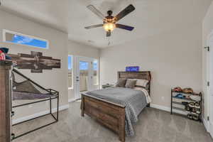 Carpeted bedroom featuring baseboards, a ceiling fan, and access to exterior