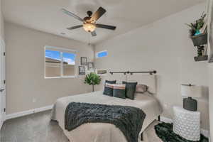 Bedroom featuring carpet, baseboards, and ceiling fan