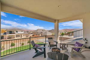 Balcony featuring a residential view and an outdoor fire pit
