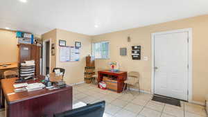 Home office featuring baseboards, light tile patterned floors, and recessed lighting