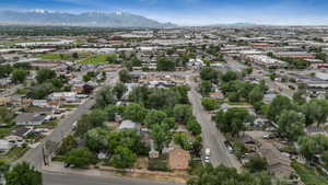 Aerial view of property and surrounding area featuring a mountain backdrop