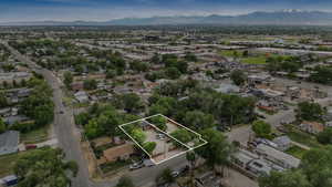 Aerial view of property and surrounding area featuring mountains and property boundaries highlighted