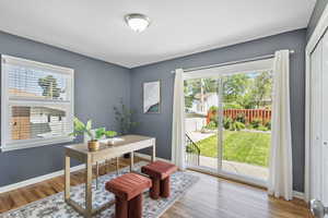 Office area with plenty of natural light, light wood-style floors, and baseboards