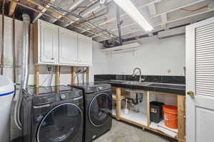 Laundry room featuring cabinet space and washing machine and clothes dryer