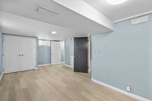 Unfurnished bedroom featuring light wood-style floors and baseboards