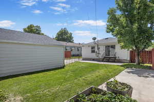 View of yard with entry steps and a patio area
