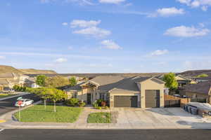 Single story home with an attached garage, stucco siding, driveway, a residential view, and a tile roof