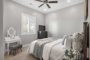 Bedroom featuring light carpet, baseboards, ceiling fan, and recessed lighting