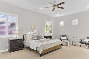 Bedroom with light colored carpet, baseboards, recessed lighting, and ceiling fan