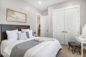 Bedroom with a closet and light carpet
