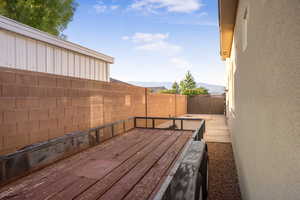 Fenced backyard featuring a deck