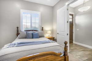Bedroom featuring light wood-style floors and baseboards
