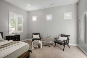 Bedroom featuring light colored carpet and baseboards