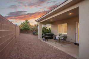 Patio terrace at dusk with a fenced backyard and a patio area