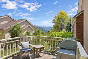 Wooden terrace with a grill and a mountain view