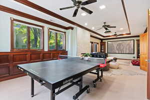 Recreation room featuring carpet, ornamental molding, a ceiling fan, plenty of natural light, and recessed lighting