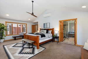 Carpeted bedroom featuring lofted ceiling, a wall mounted AC, recessed lighting, baseboards, and ceiling fan