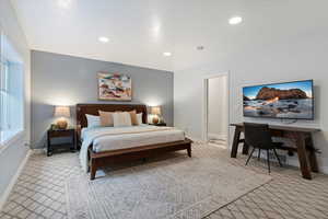 Bedroom with light colored carpet, baseboards, and recessed lighting