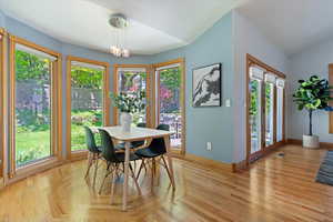 Dining room with baseboards and vaulted ceiling