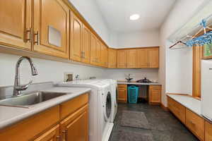 Laundry room featuring cabinet space and separate washer and dryer