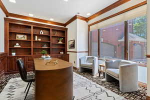 Office area with crown molding and baseboards