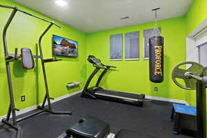 Workout room featuring baseboards