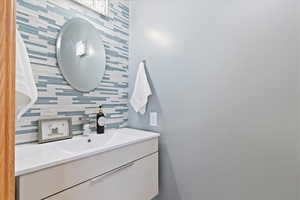 Bathroom with vanity and backsplash