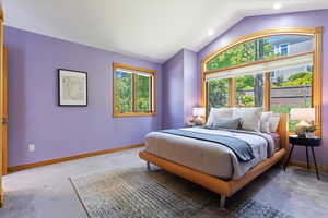 Bedroom with carpet flooring, lofted ceiling, baseboards, and recessed lighting
