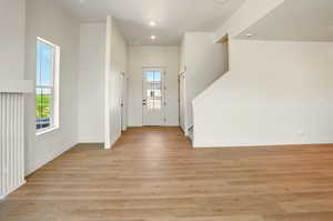 Entrance foyer with stairway, light wood-type flooring, baseboards, and recessed lighting