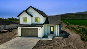 Modern farmhouse featuring driveway, an attached garage, a mountain view, and roof with shingles