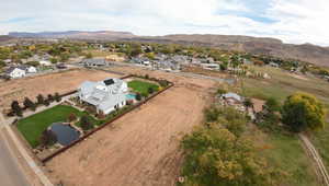 Aerial view of property's location with a water and mountain view and nearby suburban area