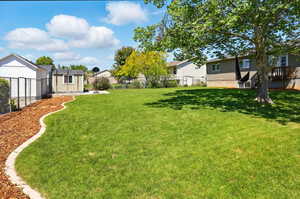 View of yard featuring an outbuilding and a residential view