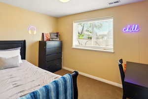 Bedroom featuring carpet flooring and baseboards