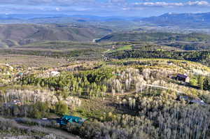 Aerial overview of property's location featuring a mountainous background