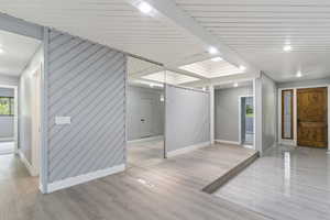 Spare room featuring baseboards and light wood-style floors