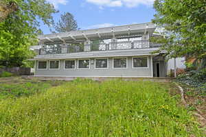 Rear view of property with a balcony