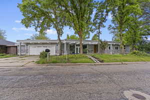 Mid-century inspired home with a garage and concrete driveway