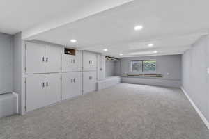Basement featuring carpet, recessed lighting, and baseboard heating