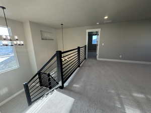 Stairs with a chandelier, baseboards, carpet floors, and recessed lighting