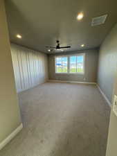 Empty room featuring ceiling fan, recessed lighting, light carpet, and baseboards