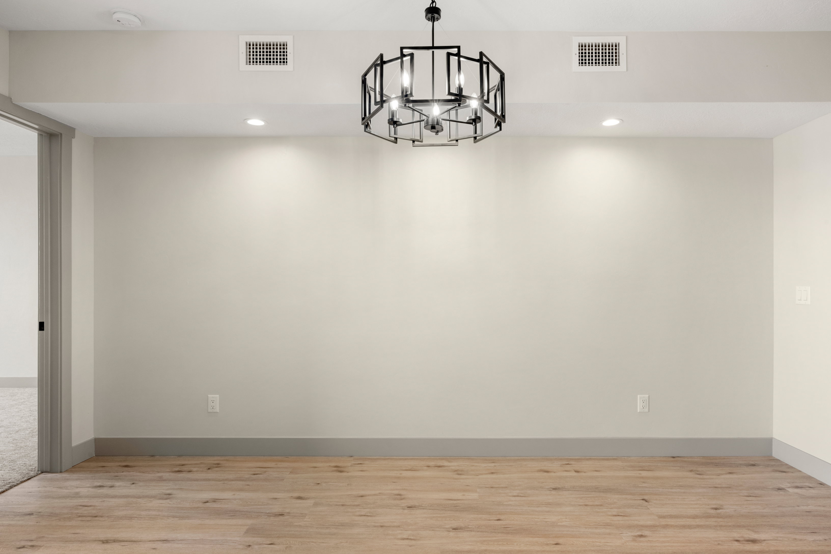 Unfurnished room featuring a chandelier, light wood finished floors, recessed lighting, a smoke detector, and baseboards
