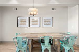 Dining space with baseboards and wood finished floors