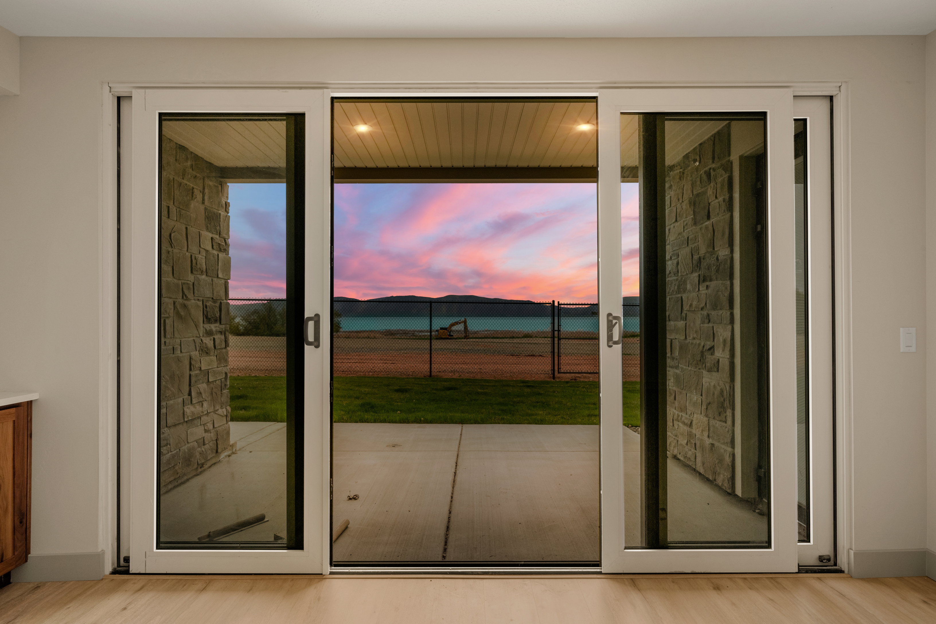 Doorway to outside with light wood finished floors and healthy amount of natural light