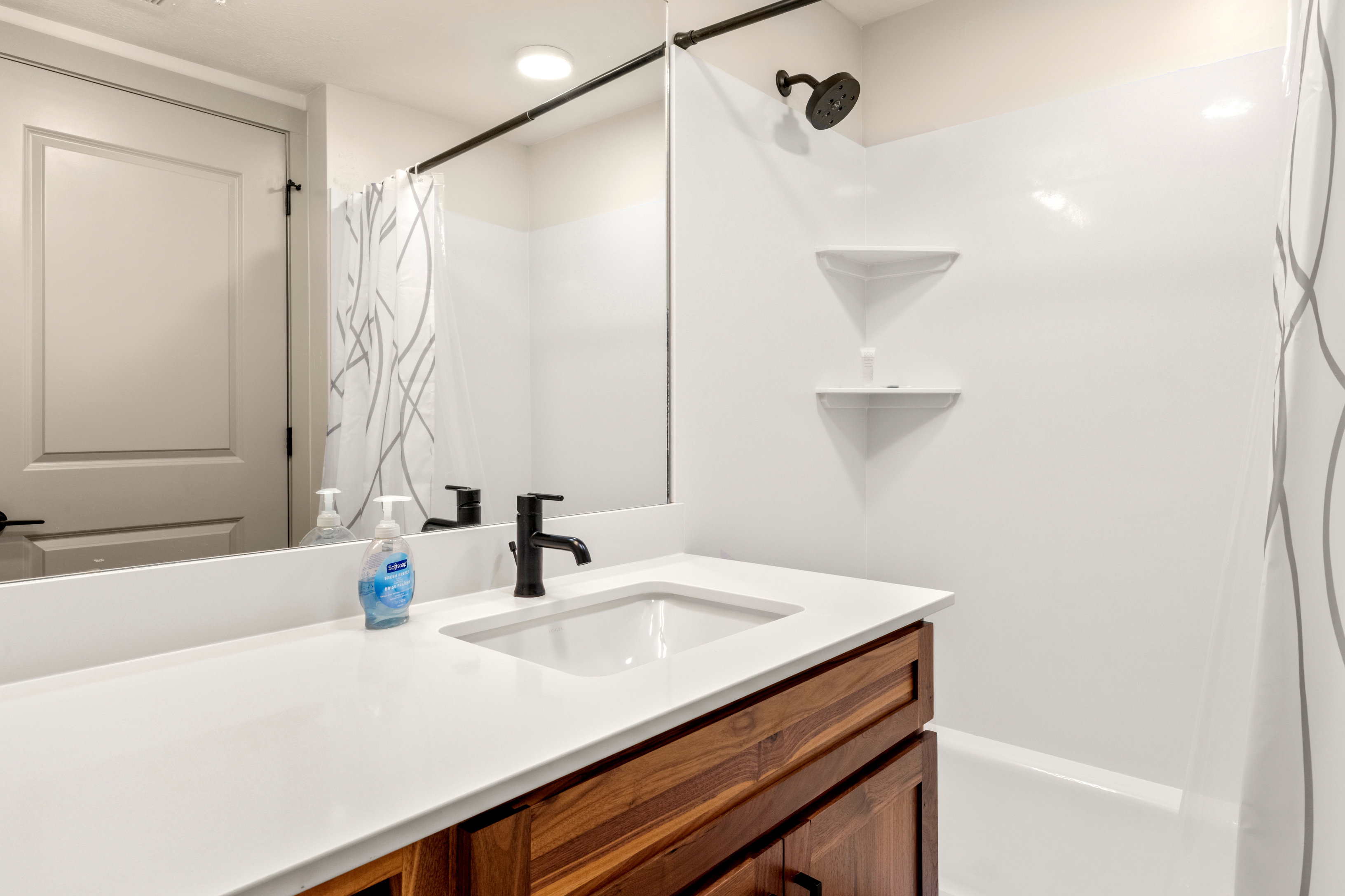 Bathroom featuring vanity and curtained shower
