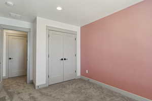 Unfurnished bedroom with baseboards, carpet floors, recessed lighting, and a closet