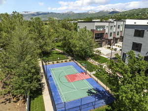 View of basketball court with a mountain view, a tennis court, and community basketball court