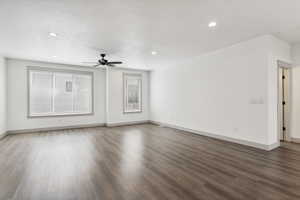 Unfurnished living room with wood finished floors, baseboards, a ceiling fan, and recessed lighting