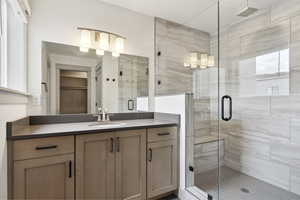 Bathroom with a stall shower and vanity