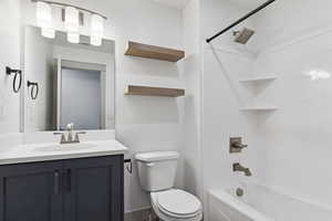 Full bathroom with toilet, bathing tub / shower combination, and vanity