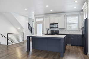 Kitchen featuring black appliances, a sink, tasteful backsplash, plenty of natural light, and recessed lighting